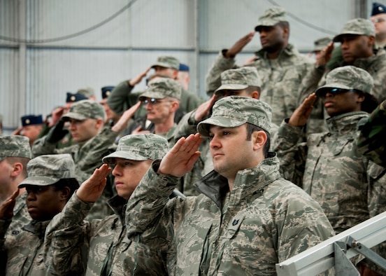 53rd Wing members salute during the National Anthem during the wing’s 70th birthday celebration Feb. 3 at Eglin Air Force Base, Fla.  The hosted a ceremony and cookout and a mini-airshow featuring six of the aircraft types that are flown by the wing.  The wing was activated Jan. 15, 1941.  (U.S. Air Force photo/Samuel King Jr.)