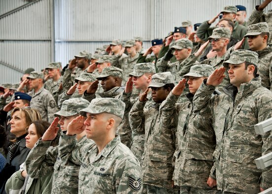 53rd Wing members salute during the National Anthem during the wing’s 70th birthday celebration Feb. 3 at Eglin Air Force Base, Fla.  The hosted a ceremony and cookout and a mini-airshow featuring six of the aircraft types that are flown by the wing.  The wing was activated Jan. 15, 1941.  (U.S. Air Force photo/Samuel King Jr.)
