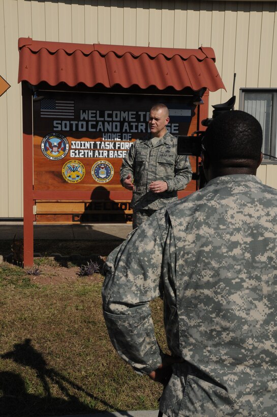 SOTO CANO AIR BASE, Honduras -- Chief Master Sgt. of the Air Force James Roy is filmed by Specialist Michael Loggins, American Forces Network, during an interview outside Base Operations here, Jan. 31. The chief visited Soto Cano and toured many facilities, conducted meet-and-greets and spoke with Airmen about key focuses in the Air Force today. (U.S. Air Force photo/Staff Sgt. Kimberly Rae Moore)
