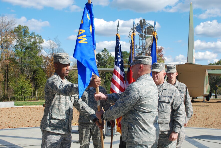 Charlotte N.C. Col Clarence Irvin hands the 145th Civil Engineering Squadron guidon to  Lt. Col. Gregory Walters during a change of command ceremony on November 6th, 2010. 