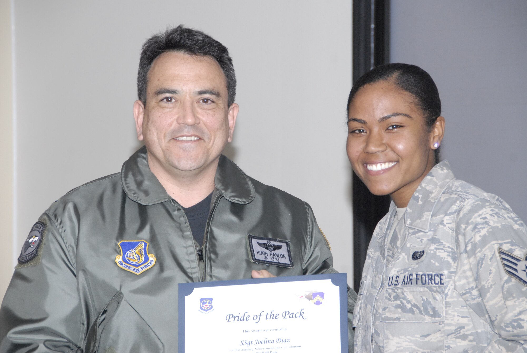 KUNSAN AIR BASE, Republic of Korea -- Col. Hugh Hanlon, 8th Fighter Wing vice commander, presents Staff Sgt. Joelina Diaz, 8th Force Support Squadron, with a Pride of the Pack award Feb. 3. (U.S. Air Force photo/Capt. Sheryll Klinkel) 
