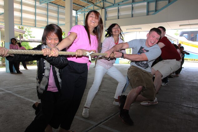 Marines and sailors play tug-of-war with disadvantaged young women during a community relations project at the Narisawat Welfare Protection and Vocational Training Centre for Women Feb. 5, 2011. Narisawat Welfare Protection and Vocational Training Centre for Women was established in 1966 to support disadvantaged women who have been taken out of human trafficing and prostitution. The Marine and sailors were in Thailand for Exercise Cobra Gold 2011, a regularly scheduled multinational training exercise.::r::::n::::r::::n::