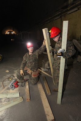 Corporals Brandon S. Mettlen, left, and James J. McNeely, Chemical, Biological, Radiological and Nuclear defense specialists with the 22nd Marine Expeditionary Unit, construct wooden braces, or shores, to secure a compromised structure during a technical rescue certification exercise, Feb. 5, 2011.  Chemical, Biological, Radiological, and Nuclear defense Marines with the 22nd Marine MEU participated in specialized classes on technical rescue during a two-week training evolution aboard the Center for National Response, in Gallagher, W.V. The Marines and sailors of the 22nd MEU are in the early stages of their pre-deployment training program, which is a series of progressively complex exercises designed to train and test the MEU's ability to operate as a cohesive and effective fighting force.