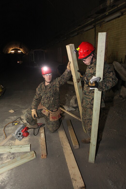 Corporals Brandon S. Mettlen, left, and James J. McNeely, Chemical, Biological, Radiological and Nuclear defense specialists with the 22nd Marine Expeditionary Unit, construct wooden braces, or shores, to secure a compromised structure during a technical rescue certification exercise, Feb. 5, 2011.  Chemical, Biological, Radiological, and Nuclear defense Marines with the 22nd Marine MEU participated in specialized classes on technical rescue during a two-week training evolution aboard the Center for National Response, in Gallagher, W.V. The Marines and sailors of the 22nd MEU are in the early stages of their pre-deployment training program, which is a series of progressively complex exercises designed to train and test the MEU's ability to operate as a cohesive and effective fighting force.