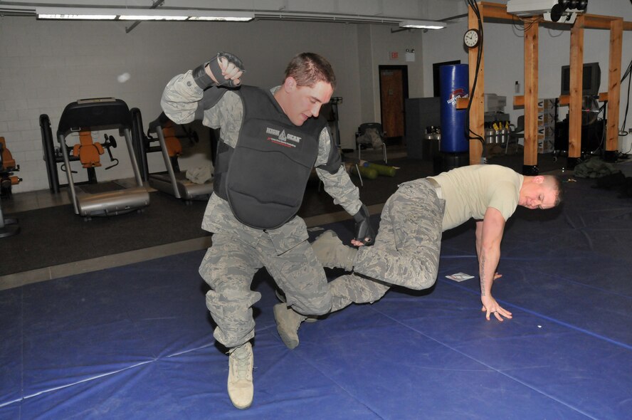 Senior Airman John Harnisch (ground) trips acting perpetrator Steven Birch (suit) both of the 934th Security Forces Squadron during defensive tactics training at the Minneapolis Air Reserve Station, Minnesota, on February 6, 2011. Security Force members are trained in personal defense to be well prepared against a real-life aggressive perpetrator. (U.S. Air Force photo/Staff Sergeant  Noah R. Johnson)