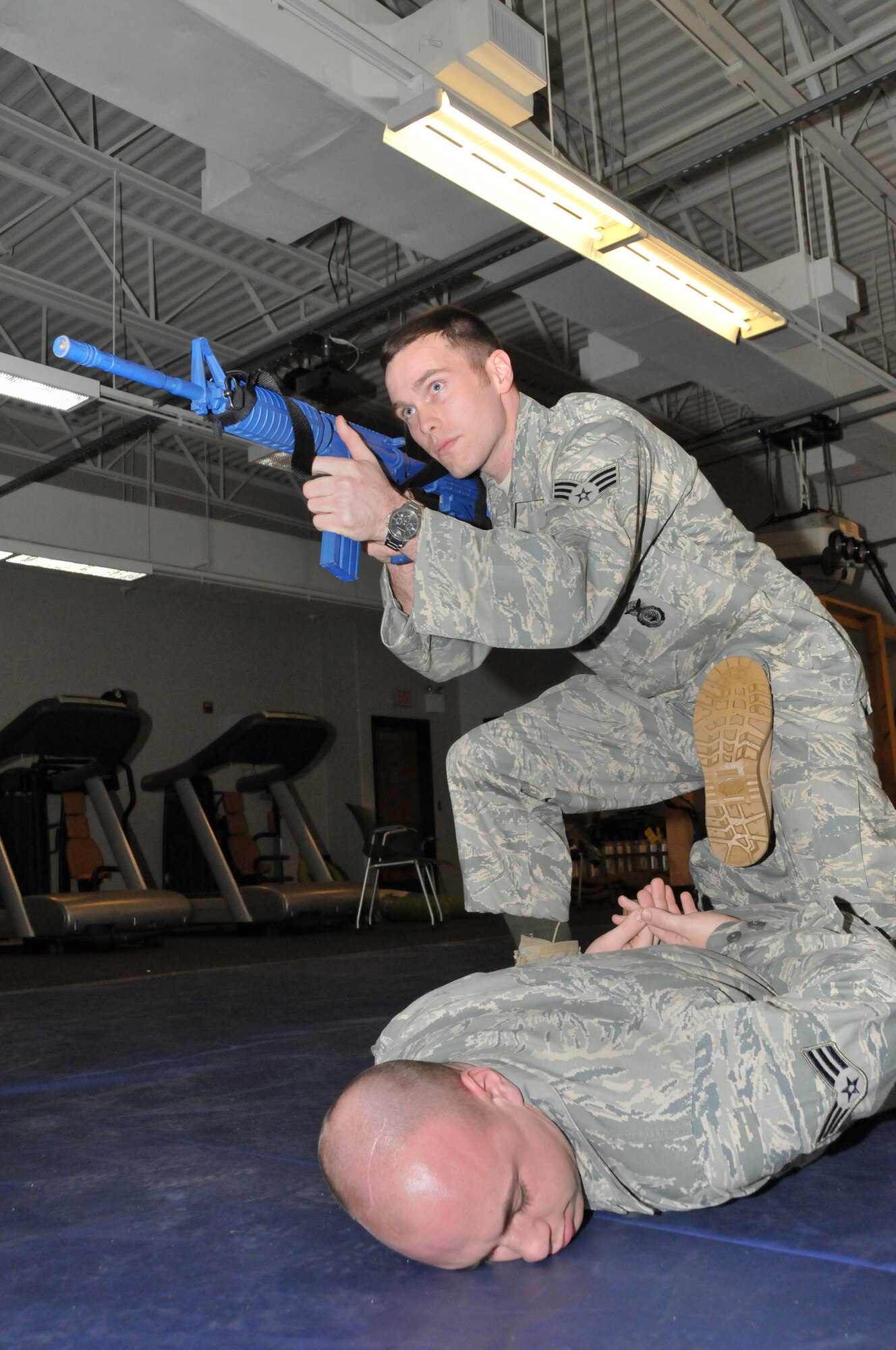 Senior Airman Kenneth Corry of the 934th Security Forces Squadron scouts the terrain for aggressors after subduing acting perpetrator Senior Amn Cody Helstern of the 934th SFS during defensive tactics training at the Minneapolis Air Reserve Station, Minnesota, on February 6, 2011. Security Force members are trained in personal defense to be well prepared against any real-life aggressive perpetrators. (U.S. Air Force photo/Staff Sergeant  Noah R. Johnson)