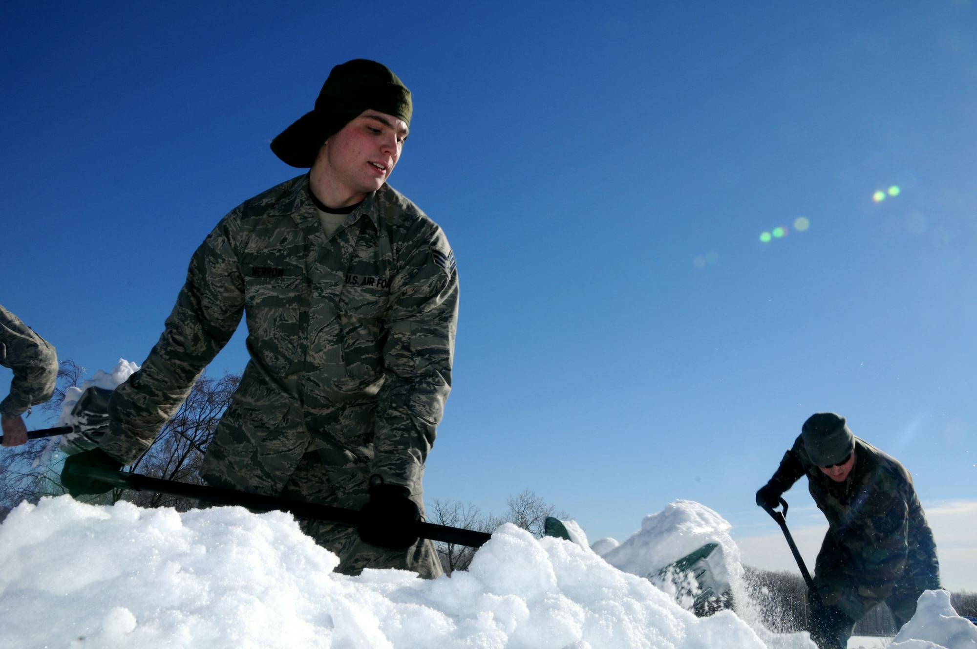 Senior Airmen Matthew Merrow, 103rd Maintenance Group, throws a shovelful of snow from the roof of Tolland High School Jan. 4, 2011, after the town's schools were closed over safety concerns and town officials requested help from the Connecticut National Guard. Approximately 125 Guardsmen were activated and worked from sunrise to sunset there and at the town’s middle school. Heavy snow this winter has recently caused several roof collapses across the state. (U.S. Air Force photo by Tech. Sgt. Tedd Andrews) 
