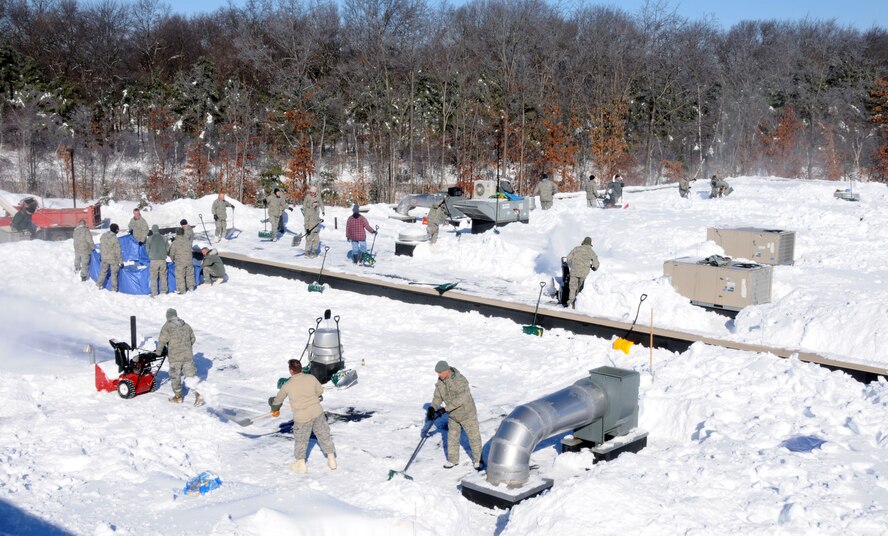 Flying Yankee Airmen with the 103rd Airlift Wing, Conn. Air National Guard, shovel and move snow off the roof of Tolland High School, Tolland, Conn., Jan. 4, 2011 after the town's schools were closed over safety concerns and town officials requested help from the Connecticut National Guard. Approximately 125 Guardsmen were activated and worked from sunrise to sunset there and at the town’s middle school. (U.S. Air Force photo by Tech. Sgt. Tedd Andrews) 
