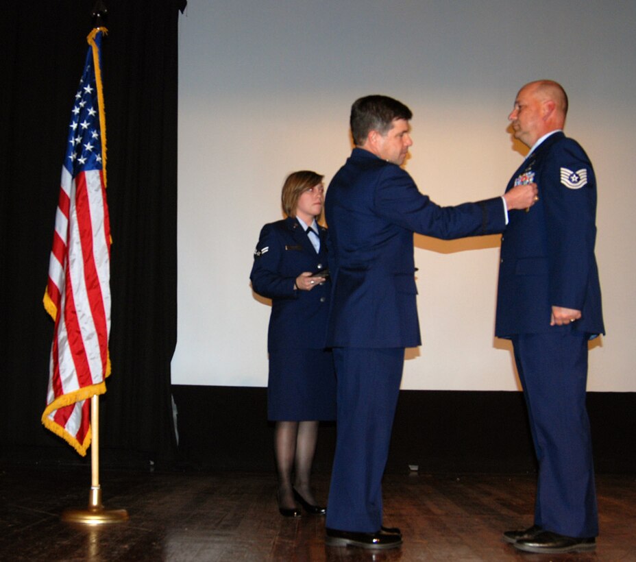 Tech. Sgt. Gerald Sonnenberg was presented with a commendation medal for his Air Force Reserve service by the 932nd Airlif Wing commander, Col. William Edwards, Jr.  Sergeant Sonnenberg is editor of the Gateway wing paper and works various public relations projects throughout the year.  (U.S. Air Force photo/Tech. Sgt. Daniel Oliver)