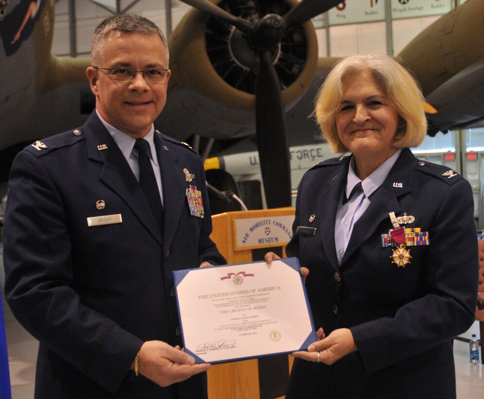 Col. Randal L. Bright, 512th Airlift Wing commander, presents Col. Elaine K. Barron, 512th Mission Support Group commander, with the Legion of Merit Award during her retirement ceremony Feb. 5 at the Air Mobility Command Museum, Dover Air Force Base, Del. The ceremony honored the many accomplishments of Colonel Barron during her 31-year career in the Air Force and Air Force Reserve. (U.S. Air Force photo by Staff Sgt. Andria J. Allmond/Released)