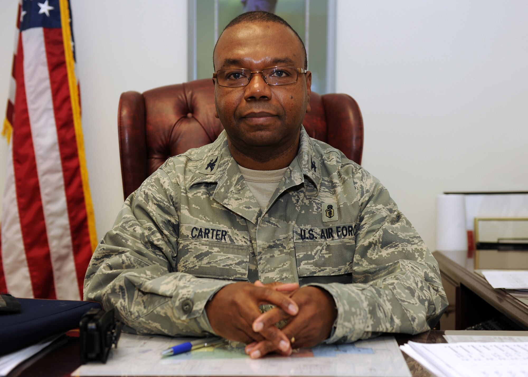 The 174th Fighter Wing Medical Group Commander Col. Wenzell E. Carter, Jr. seated at his desk during the February Unit Training Assembly. (USAF Photo By: Staff Sgt. James N. Faso II/ RELEASED)