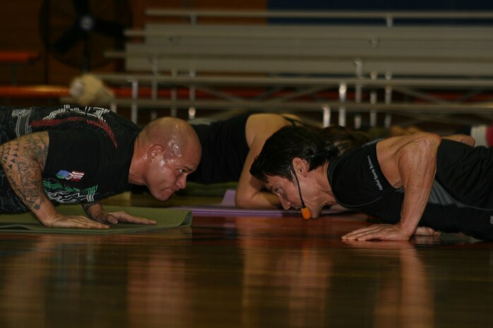 Adrian R. Figueroa, goes head-to-head with Tony Horton here at the IronWorks Gym sports courts Monday. Horton sifted through the crowd, encouraging participants to stay focused and keep intensity at peak levels as the program progressed. Participants endured five intense levels for over an hour as they worked with Horton.
