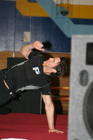 Tony Horton demonstrates his balance and dexterity during an exercise demonstration at the IronWorks Gym sports courts here Monday. Horton challenged participants to continue training if they wanted to see results.erpoint