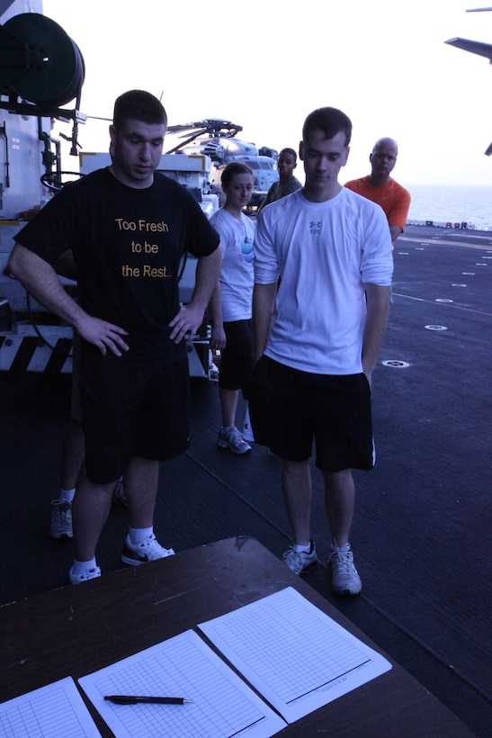 USS KEARSARGE, At Sea (Feb. 7, 2011) – Participants line up to register in their age groups before the Run To Nowhere, a 5K race held Feb. 7, 2011. Marines and sailors with 26th Marine Expeditionary Unit and USS Kearsarge participated in the run, which spanned from the bow to the stern of the ship as well as the cavernous hangar bay. Elements of 26th MEU are currently operating aboard ships of the Kearsarge Amphibious Ready Group in the U.S. 5th Fleet area of responsibility. (Official USMC photo by Lance Cpl. Michael S. Lockett)::r::::n::