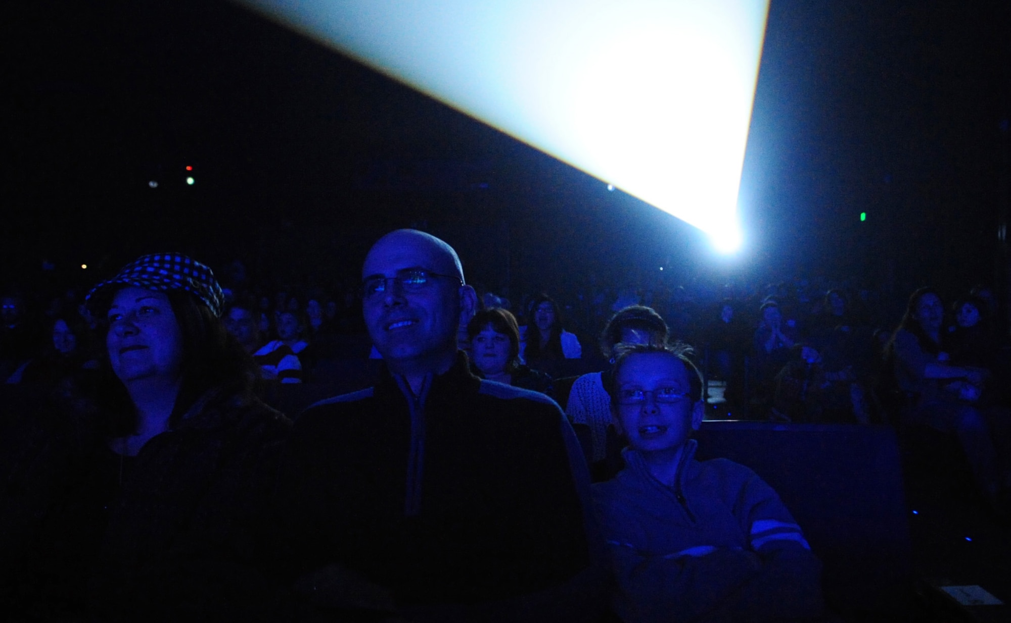 Chief Master Sergeant Alexander Del Valle watches the Tops In Blue performance with his family February 3, 2011Eielson Air Force Base, Alaska. Tops In Blue have been entertaining Air Force service members and their families at home and abroad for over 56 years. CMSgt Del Valle is the superintendent of the 354th Operations Group. (U.S. Air Force photo/Airman 1st Class Laura Goodgame)