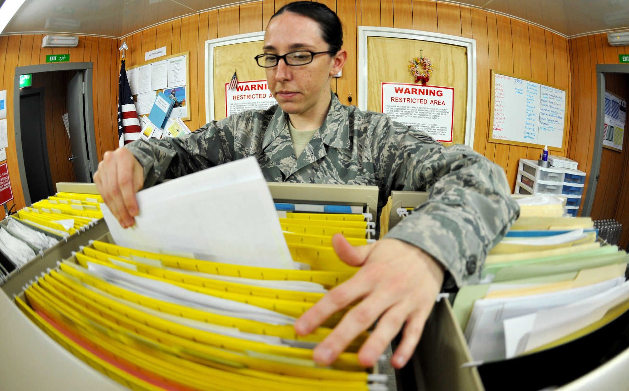 Staff Sgt. Porsha Harris files inventory paperwork in her office, Jan. 29, 2011, on Contingency Operating Base Speicher, Iraq. Sergeant Harris is a customer service and data management representative for COB Speicher's redistribution property assistance team. (U.S. Air Force photo/Senior Airman Andrew Lee) 