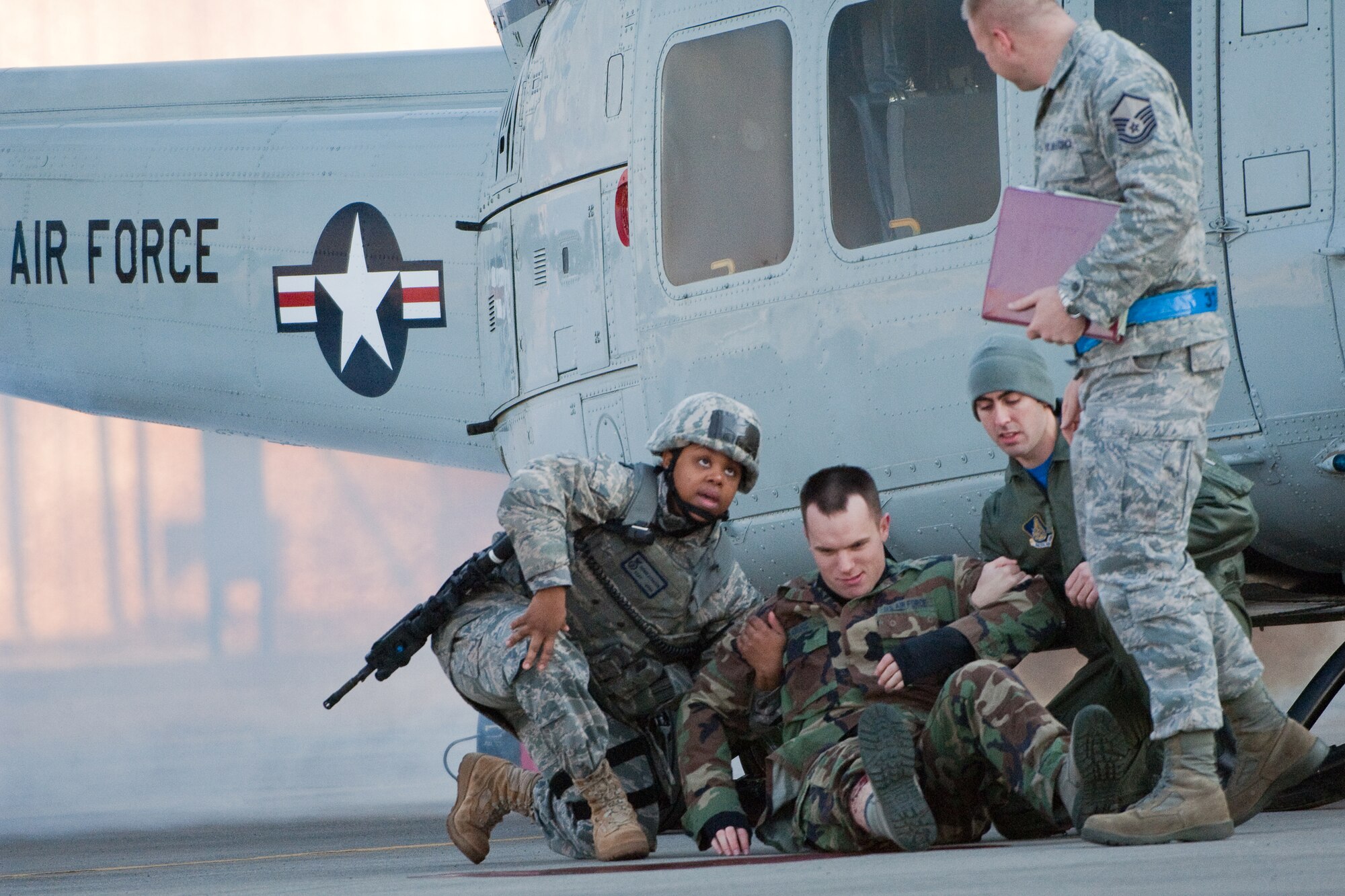 YOKOTA AIR BASE, Japan -- Personnel participating in an Emergency Management Exercise here Feb. 4, perform patient transport during a simulated aircraft crash scenario. (U.S. Air Force photo/Osakabe Yasuo) 