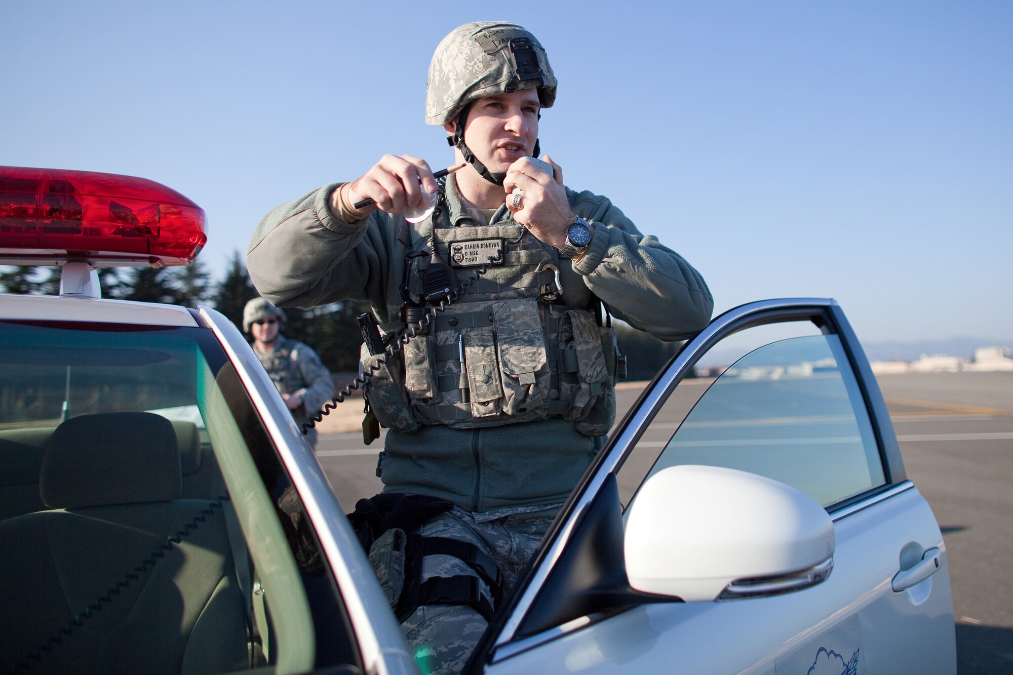 YOKOTA AIR BASE, Japan -- Tech. Sgt. Darrin Donovan, 374th Security Forces Squadron, reports information to the Law Enforcement desk after arriving at a simulated aircraft crash site during an Emergency Management Exercise here Feb. 4. (U.S. Air Force photo/Osakabe Yasuo)