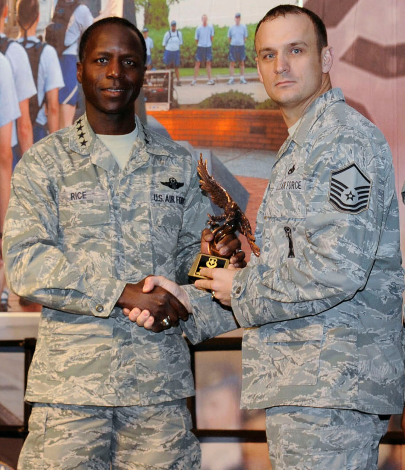 General Edward A. Rice Jr., Air Education and Training Command, commander, Randolph Air Force Base, Texas, presents Master Sgt. Cameron Johnson, Airey NCO Academy instructor, with the 2010 Air Education and Training Command Enlisted Educator of the Year Award at the AETC Symposium in San Antonio. (U.S. Air Force photo by Mr. Don Lindsey) 