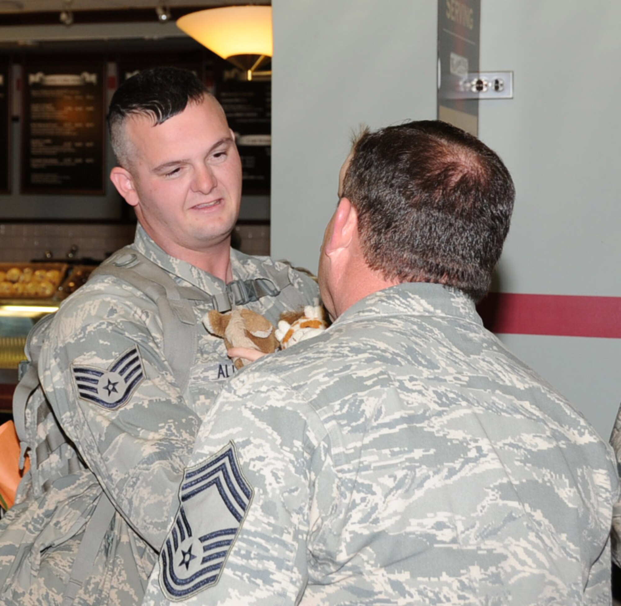 Staff Sgt. Edward Allred of the 931st Civil Engineering Squadron is greeted by Chief Master Sgt.Robert Stephenson Maintenance Group Superintendent, 931st Air Refueling Group, upon his return from a deployment in Southwest Asia, Feb. 4. Members of the 931st ARG showed up at the Midcontintinental Airport in Wichita to support Sergeant Allred and five other reservists from the 931st CES. (Air Force Photo by Tech. Sgt. Brannen Parrish)