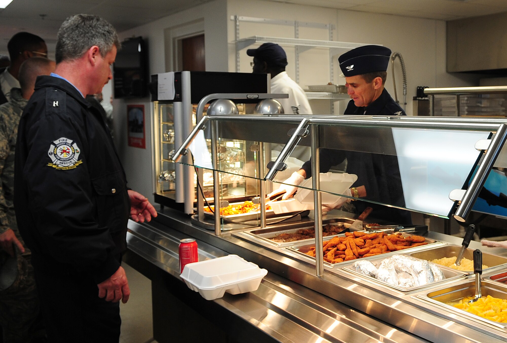 MOODY AIR FORCE BASE, Ga.-- Col. Mark Ruse, 23rd Mission Support Group commander, works the serving line during the opening ceremony of the Turn N' Burn Flight Kitchen Feb. 7. All meals provided by the flight kitchen are premade for quick service to Airmen who work on the flightline. (U.S. Air Force photo/Senior Airman Stephanie Mancha)(RELEASED)