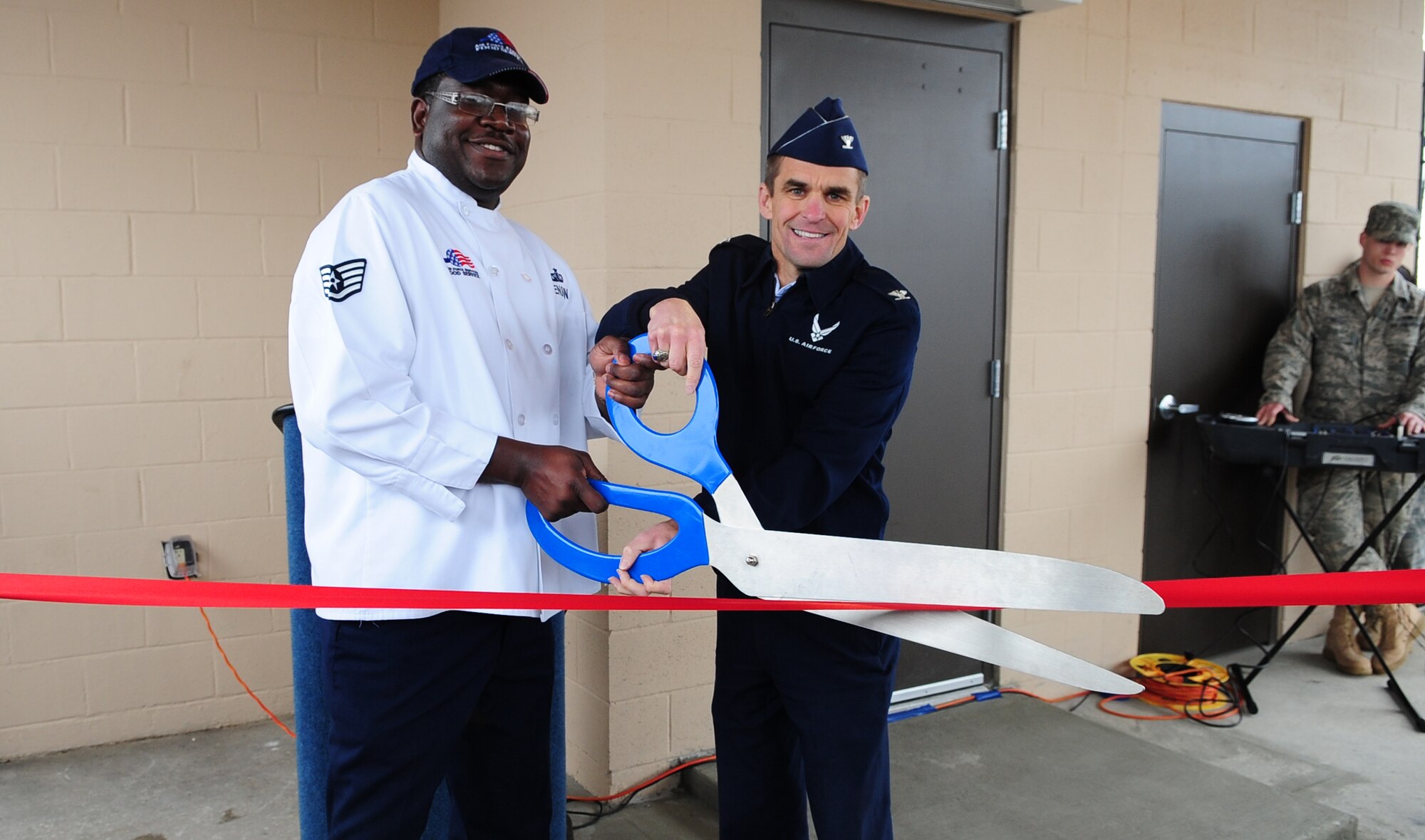MOODY AIR FORCE BASE, Ga.--  Staff Sgt. Kenneth Henson, 23rd Force Support Squadron Turn-n-Burn Flight Kitchen manager, and Col. Mark Ruse, 23rd Mission Support Group commander, cut the ribbon during the opening ceremony of the Turn N' Burn Flight Kitchen Feb. 7. The flight kitchen was built so military members working on the flightline have better access to meals. (U.S. Air Force photo/Senior Airman Stephanie Mancha)(RELEASED)