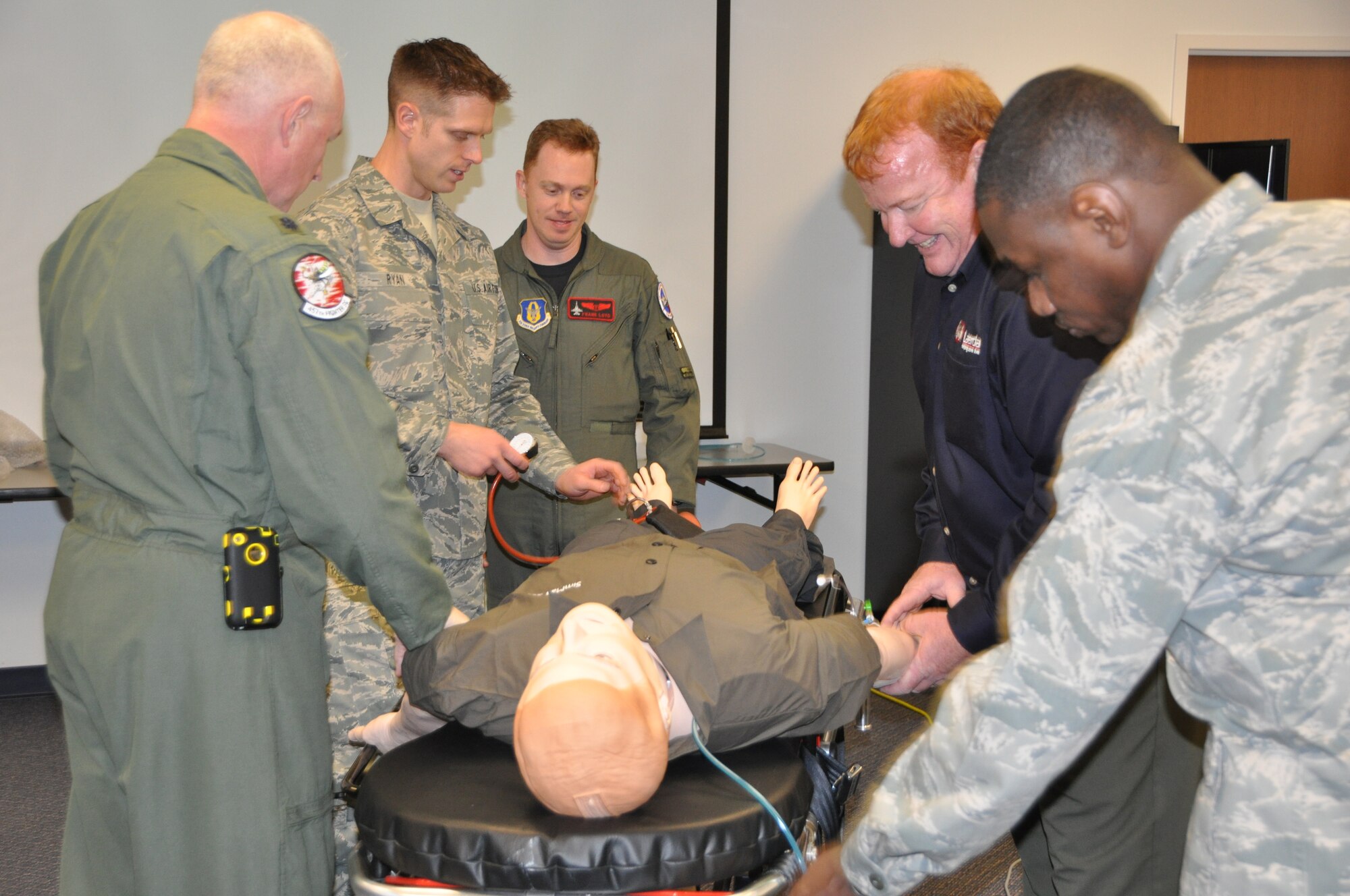 Medical personnel receive hands-on experience with SimMan 3G during a training session Jan. 5, 2011. The training took place at the 301st Medical Squadron at Naval Air Station Fort Worth Joint Reserve Base, Texas. The robotic mankin simulates numerous types of medical emergencies, including chemical exposure. (U.S. Air Force photo/SrA Melissa Harvey).