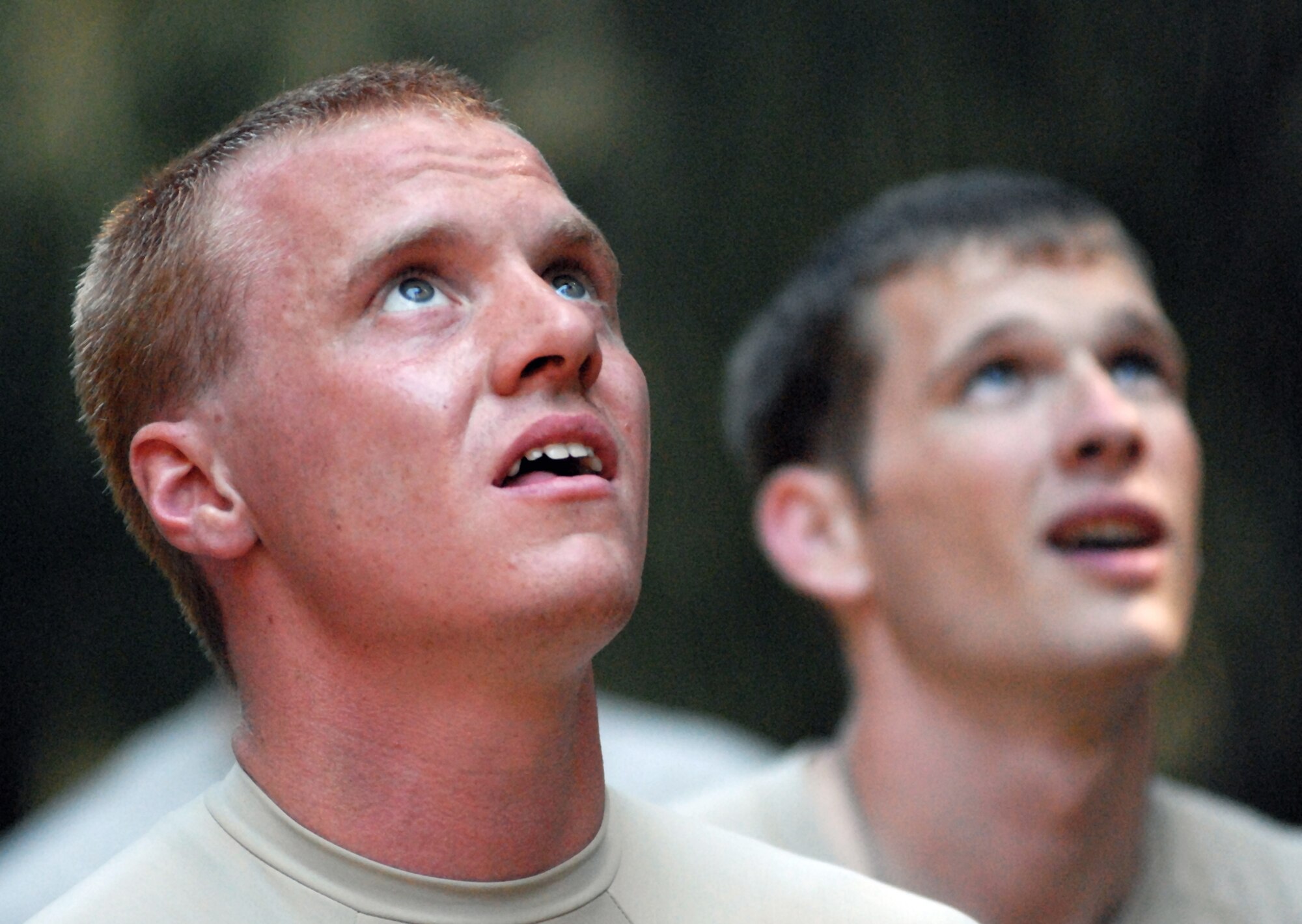 Senior Airmen Ray Burk and Jordan Miller watch as their fellow Airmen complete an obstacle course during try-outs for the Army Air Assault Course Feb. 1, 2011, in Wahiawa, Hawaii. Sixteen security forces members are scheduled to attend the two-week Air Assault Course beginning May 5, 2011. Airmen Burk and Miller are assigned to the 647th Security Forces Squadron. (U.S. Air Force photo/Staff Sgt. Carolyn Viss) 