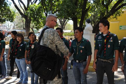 SOTO CANO AIR BASE, Honduras -- Col. Gregory Reilly, Joint Task Force-Bravo commander, is greeted at Hospital del Sur by the Honduran Boy and Girl Scouts. The scouts acted as interpreters, moved patients from surgery to recovery and aided families as they waited for their loved ones being treated in the opthamology Medical Readiness Training Exercise in Choluteca. JTF-Bravo is committed to full partnerships with Central American governments in training and missions to support security, stability and prosperity throughout the region. (U.S. Air Force photo/Staff Sgt. Kimberly Rae Moore)