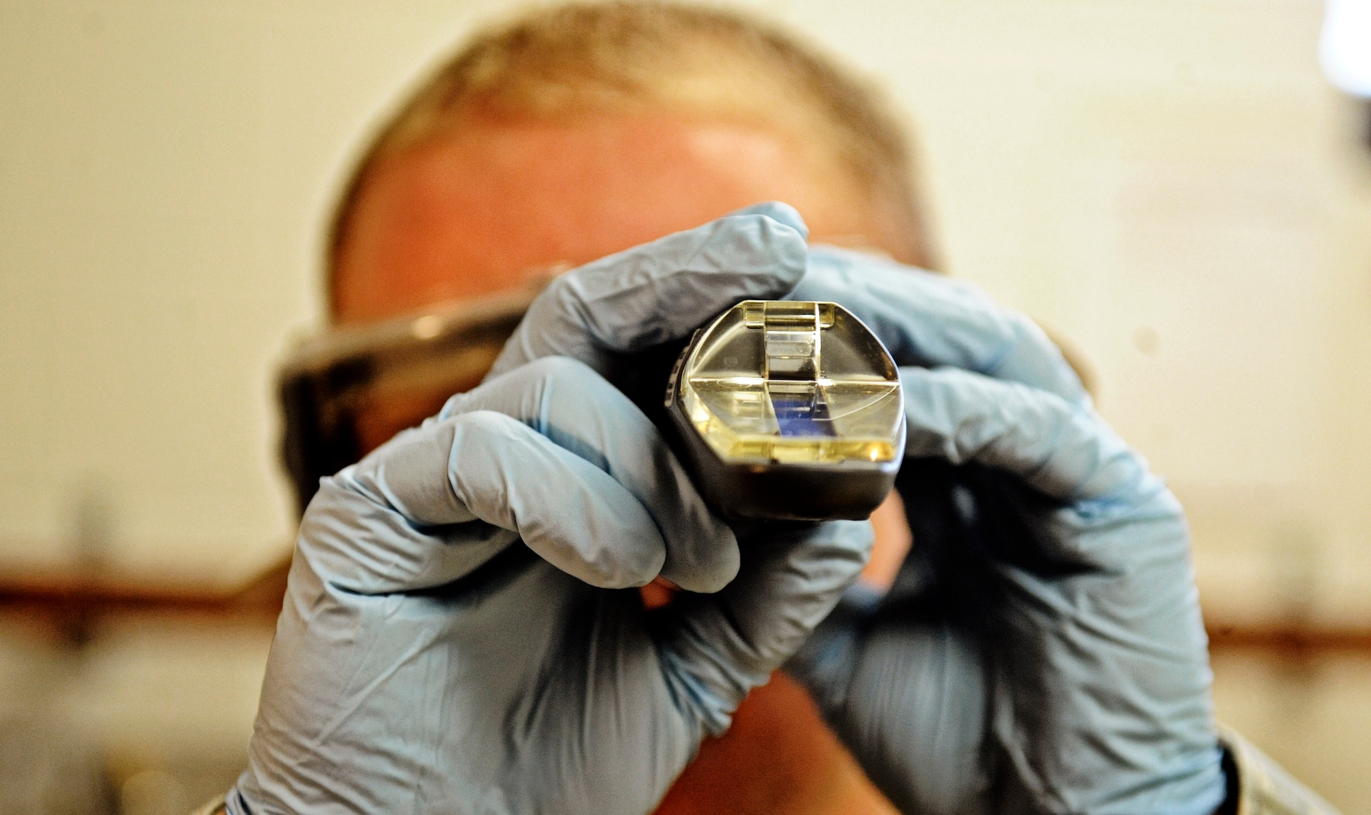 Airman 1st Class Lucas Sinnott, 375th Logistics Readiness Squadron fuels lab technician, observes a fuel sample for additives Feb 4, 2011 at Scott Air Force Base. The petroleum, oils and lubricants flight laboratory is responsible for testing fuel quality along with other aspects of the fuel. (U.S. Air Force photo/ Staff Sgt. Ryan Crane)