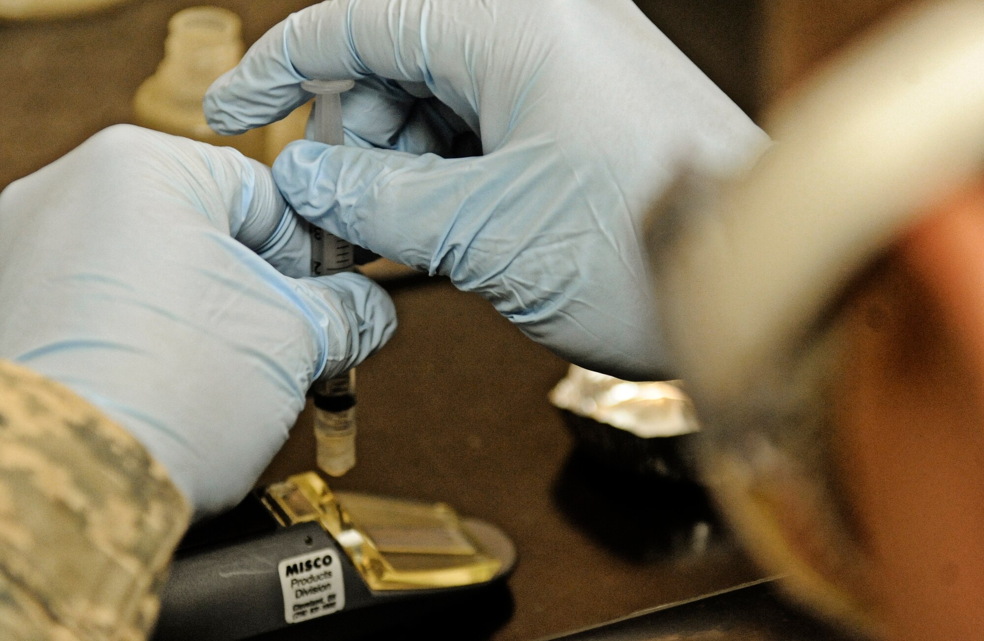 Airman 1st Class Lucas Sinnott, 375th Logistics Readiness Squadron fuels lab technician, deposits a fuel sample onto a device that measures fuel additives Feb 4, 2011 at Scott Air Force Base. The petroleum, oils and lubricants flight laboratory is responsible for testing fuel quality along with other aspects of the fuel. (U.S. Air Force photo/ Staff Sgt. Ryan Crane)