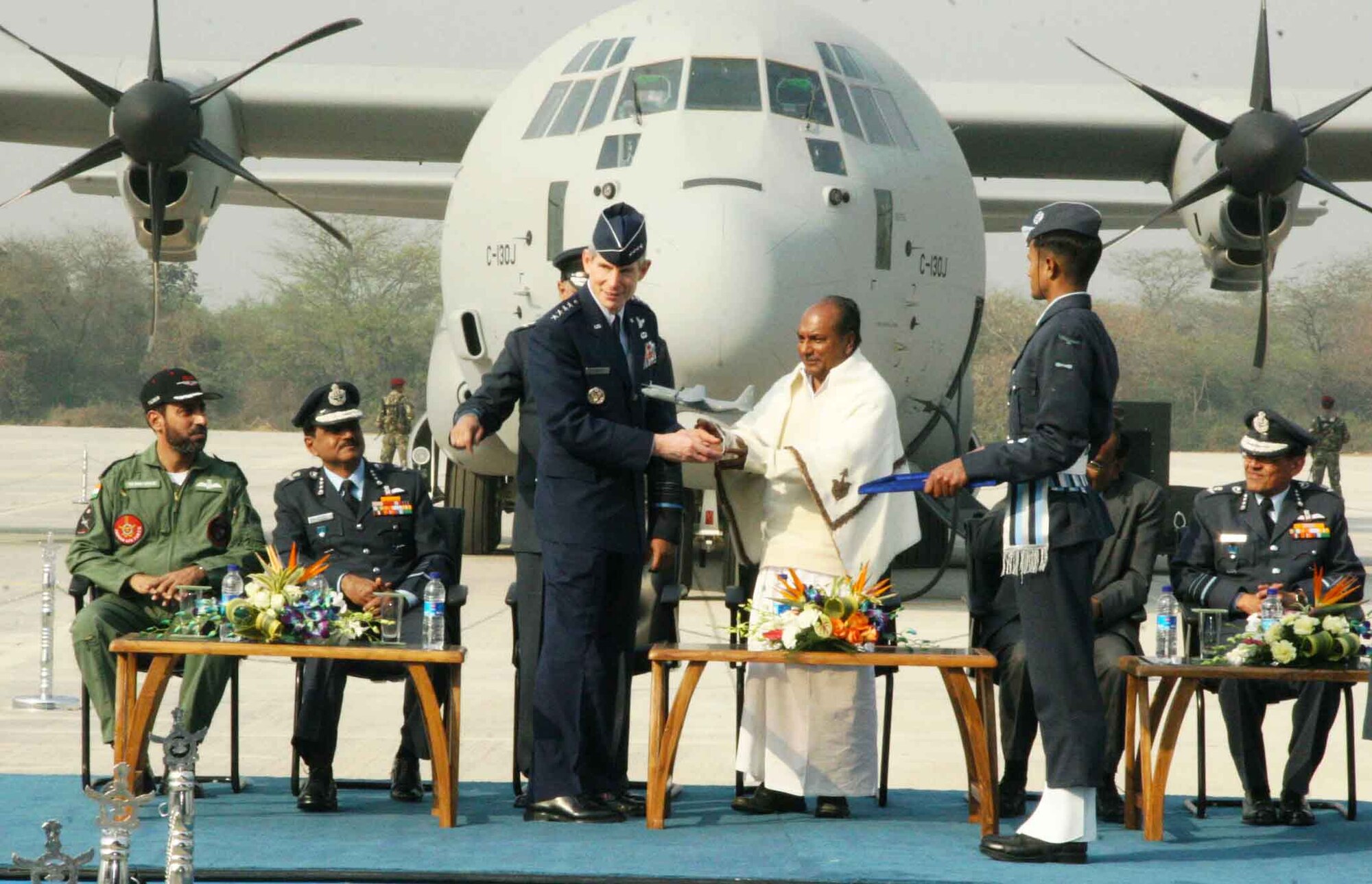 Air Force Chief of Staff Gen. Norton Schwartz presents a model of the C-130J Super Hercules to Indian Defense Minister A.K. Antony (center) at a ceremony Feb. 5, 2011, at Hindon Air Force Station near New Delhi, India.  The Indian Air Force inducted the first of six C-130Js aircraft into its mobility fleet.  (Courtesy photo)