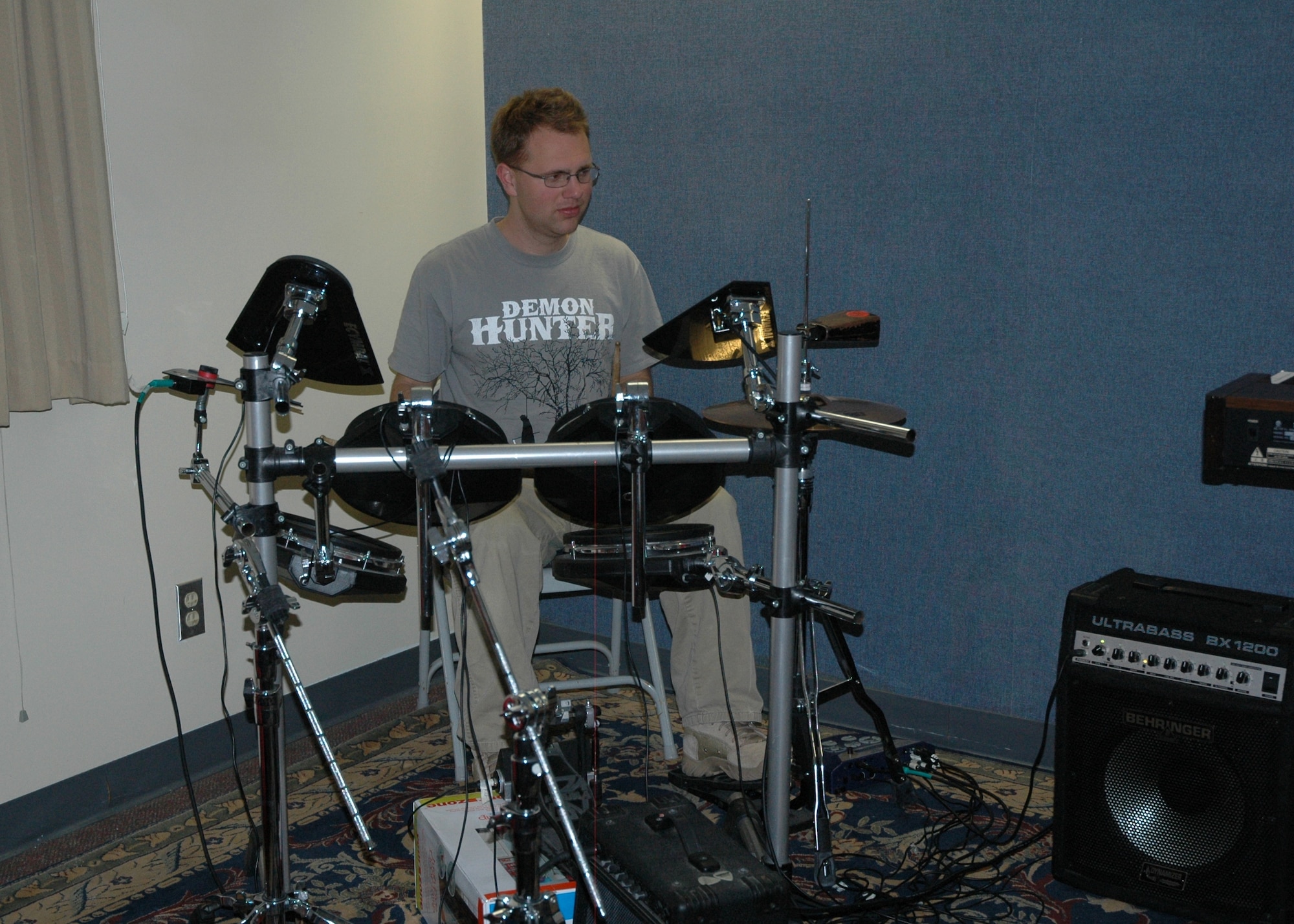 An Airman takes a break from watching the NFL Super Bowl to practice his drum skills Feb. 6. The music room is one of seven rooms that make up the new Airmen Center called "Lighthouse" for Eglin dorm residents. The complex offers a full kitchen, video gaming options, music studio and surround sound movie experiences with TV screens up to 73” at Dorm 18 D's third floor. Entrance for the facility is accessible from the Airmen Leadership School's parking lot. (U.S. Air Force photo/Chrissy Cuttita)