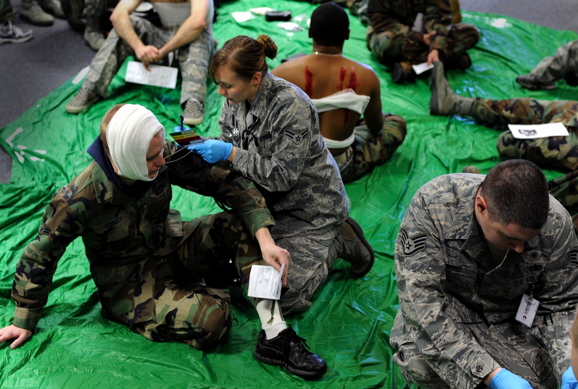 509th Medical Group Airmen perform triage on casualties suffering from explosion wounds during a mass casualty exercise, Feb. 4, 2011, Whiteman Air Force Base. Airmen spent several hours responding to an explosion scenario where more than 50 Airmen and civilians had been severely injured and were in need of immediate medical aid. Whiteman medics performed the exact procedures that they would in a real world situation to include loading patients into ambulances for transport to medical facilities.  (U.S. Air Force photo by Senior Airman Kenny Holston)(Released) 