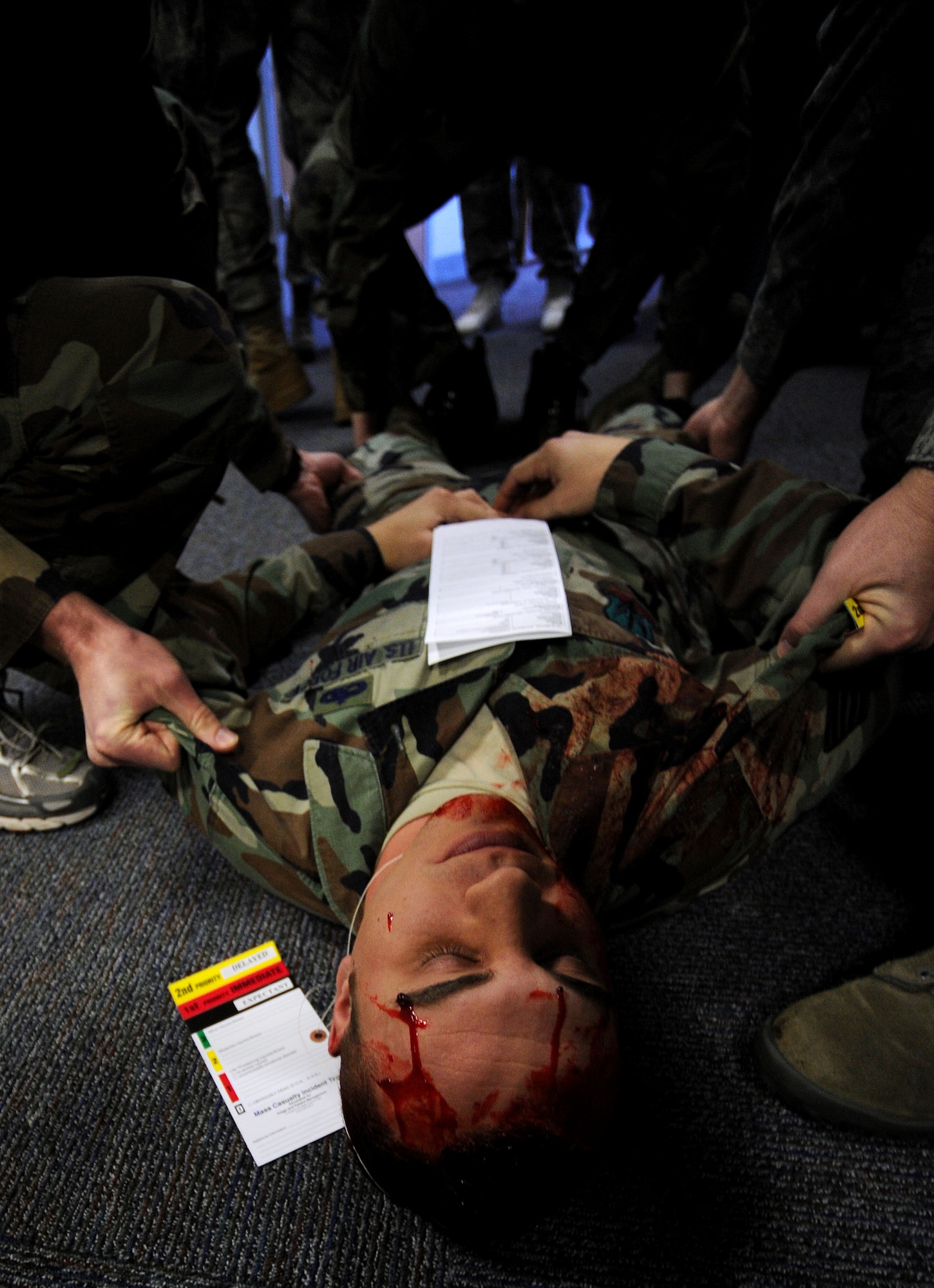 509th Medical Group Airmen prepare to move a simulated dead casualty during a mass casualty exercise, Feb. 4, 2011, Whiteman Air Force Base. Airmen spent several hours responding to an explosion scenario where more than 50 Airmen and civilians had been severely injured and were in need of immediate medical aid. Whiteman medics performed the exact procedures they would in a real world situation to include loading patients into ambulances for transport to medical facilities.  (U.S. Air Force photo by Senior Airman Kenny Holston)(Released) 