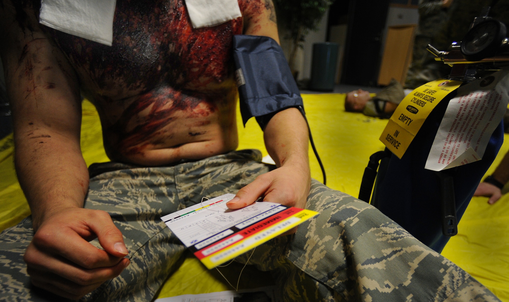 A severely wounded Airman waits for further medical attention during a mass casualty exercise, Feb. 4, 2011, Whiteman Air Force Base. Airmen spent several hours responding to an explosion scenario where more than 50 Airmen and civilians had been severely injured and were in need of immediate medical aid. Whiteman medics performed the exact procedures they would in a real world situation to include loading patients into ambulances for transport to medical facilities.  (U.S. Air Force photo by Senior Airman Kenny Holston)(Released) 