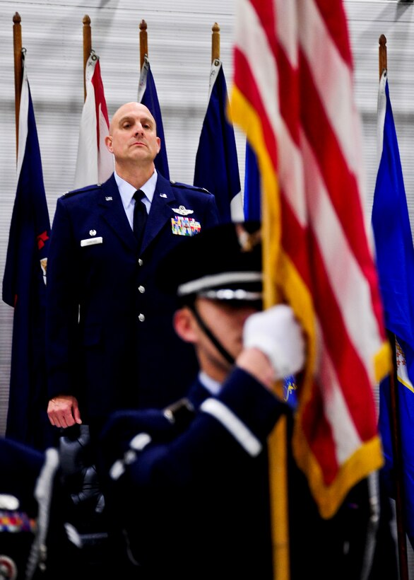 Col. Andy Comtois, 919th Special Operations Wing commander, observes the American flag during the national anthem at the assumption of command ceremony Feb. 5 at Duke Field, Fla.  Colonel Comtois assumed command of the Air Force Reserve’s most decorated wing in the formal ceremony in front of hundreds of Airmen and distinguished visitors.  (U.S. Air Force photo/Tech. Sgt. Samuel King Jr.)