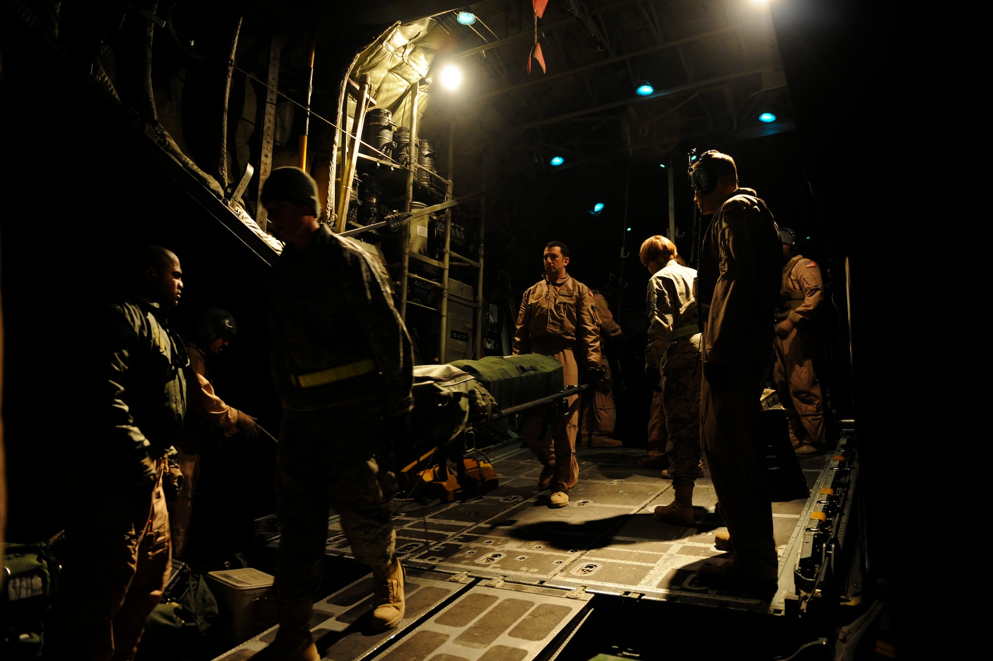 U.S. Air Force medical personnel unload equipment from a C-130H Hercules during an aeromedical evacuation mission in support of Operation Enduring Freedom at Camp Bastion, Afghanistan, Jan. 7, 2011.  C-130s are able to land on runways that many other fixed wing aircraft are unable to, making them invaluable when moving patients in austere locations. (U.S. Air Force photo by Staff Sgt. Eric Harris) 