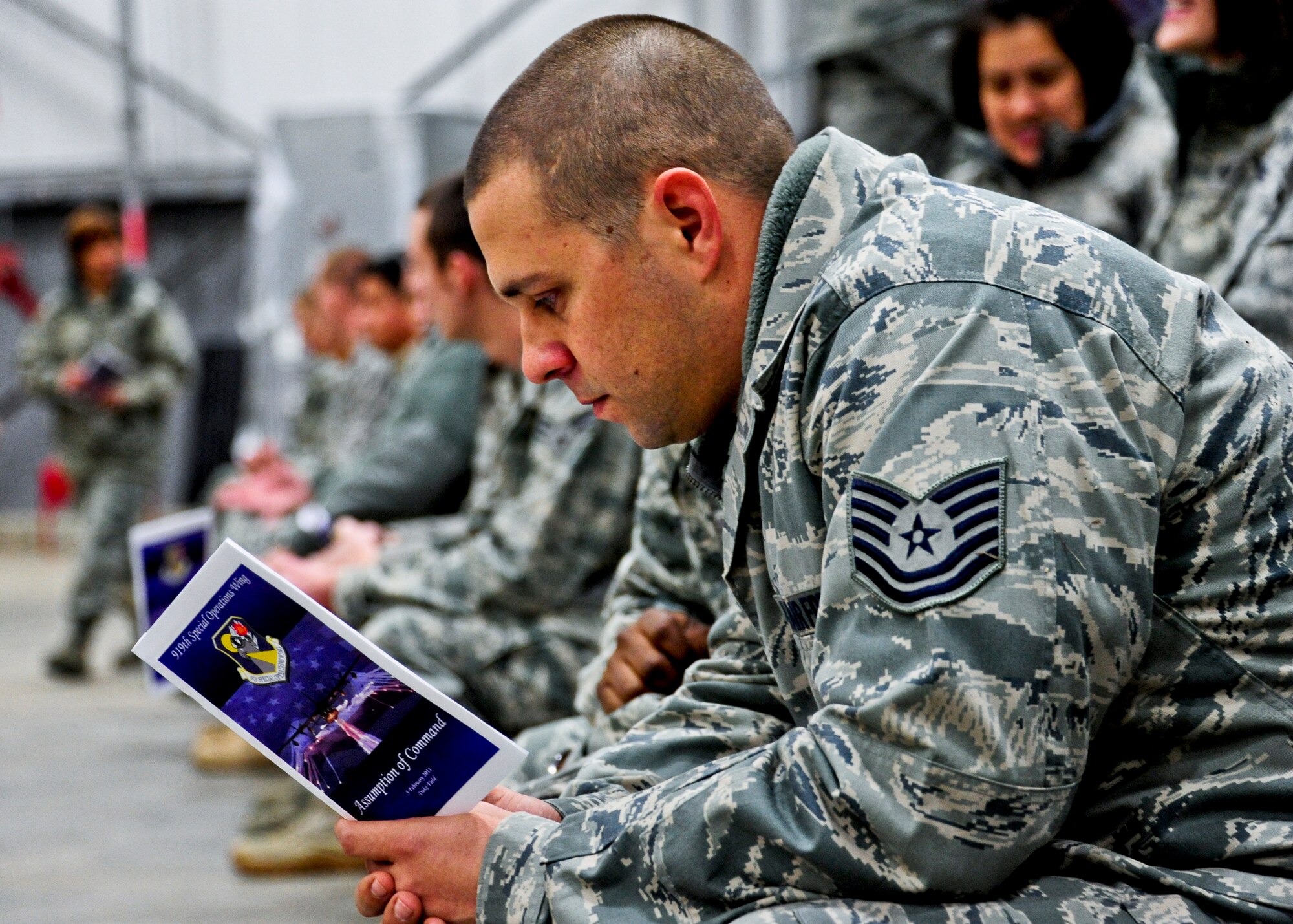 A 919th Special Operations Wing Airman reviews the program preceding the assumption of command ceremony Feb. 5 at Duke Field, Fla.  Col. Andy Comtois assumed command of the Air Force Reserve’s most decorated wing in the formal ceremony in front of hundreds of Airmen and distinguished visitors.   (U.S. Air Force photo/Tech. Sgt. Samuel King Jr.)