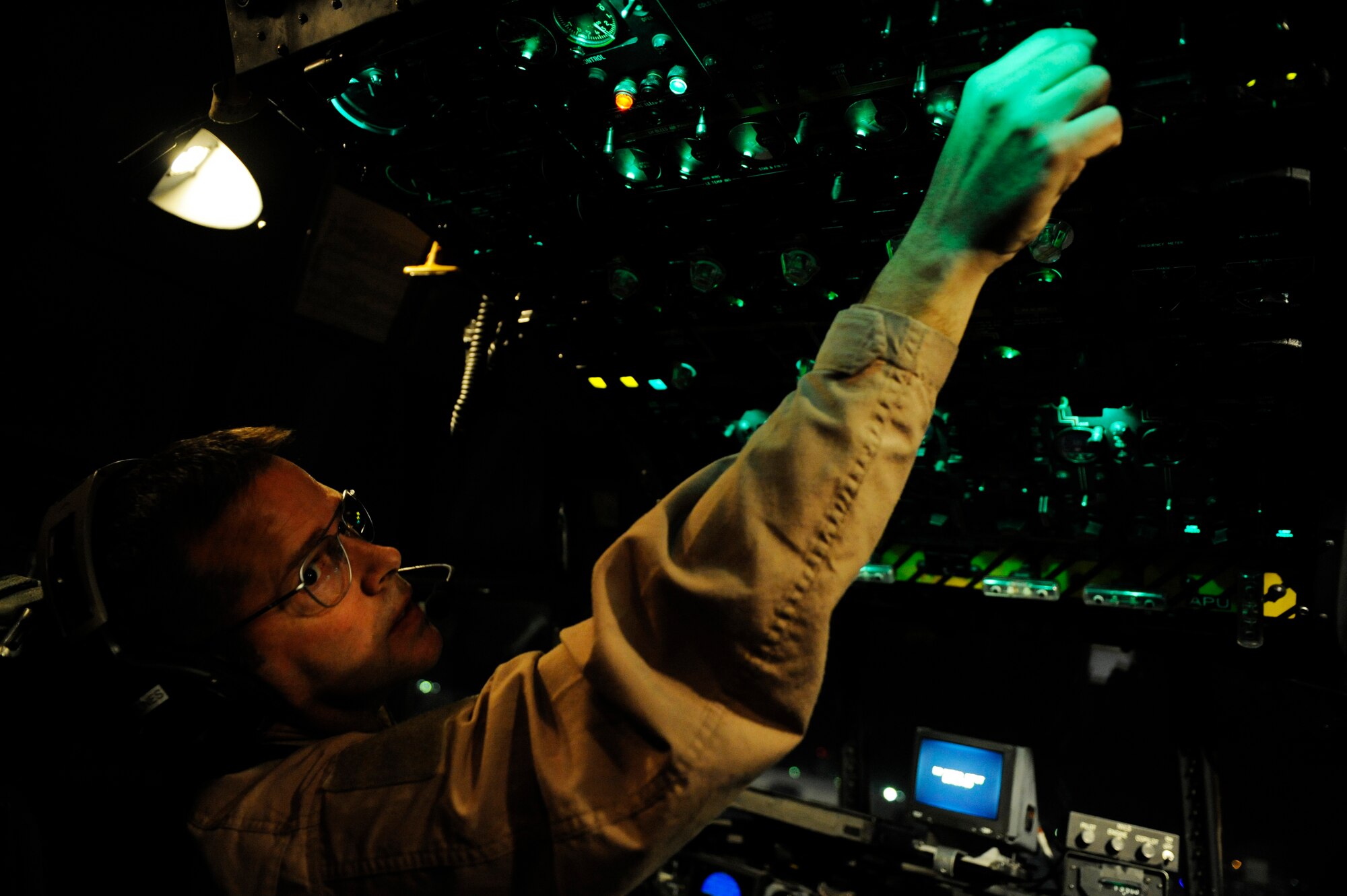 U.S. Air Force Master Sgt. Robert Semones, 774th Expeditionary Airlift Squadron, conducts pre-flight checks aboard a C-130H Hercules before an aeromedical evacuation mission in support of Operation Enduring Freedom at Bagram Airfield, Afghanistan, Jan. 7, 2011.  C-130s are able to land on runways that many other fixed wing aircraft are unable to, making them invaluable when moving patients in austere locations. (U.S. Air Force photo by Staff Sgt. Eric Harris) 
