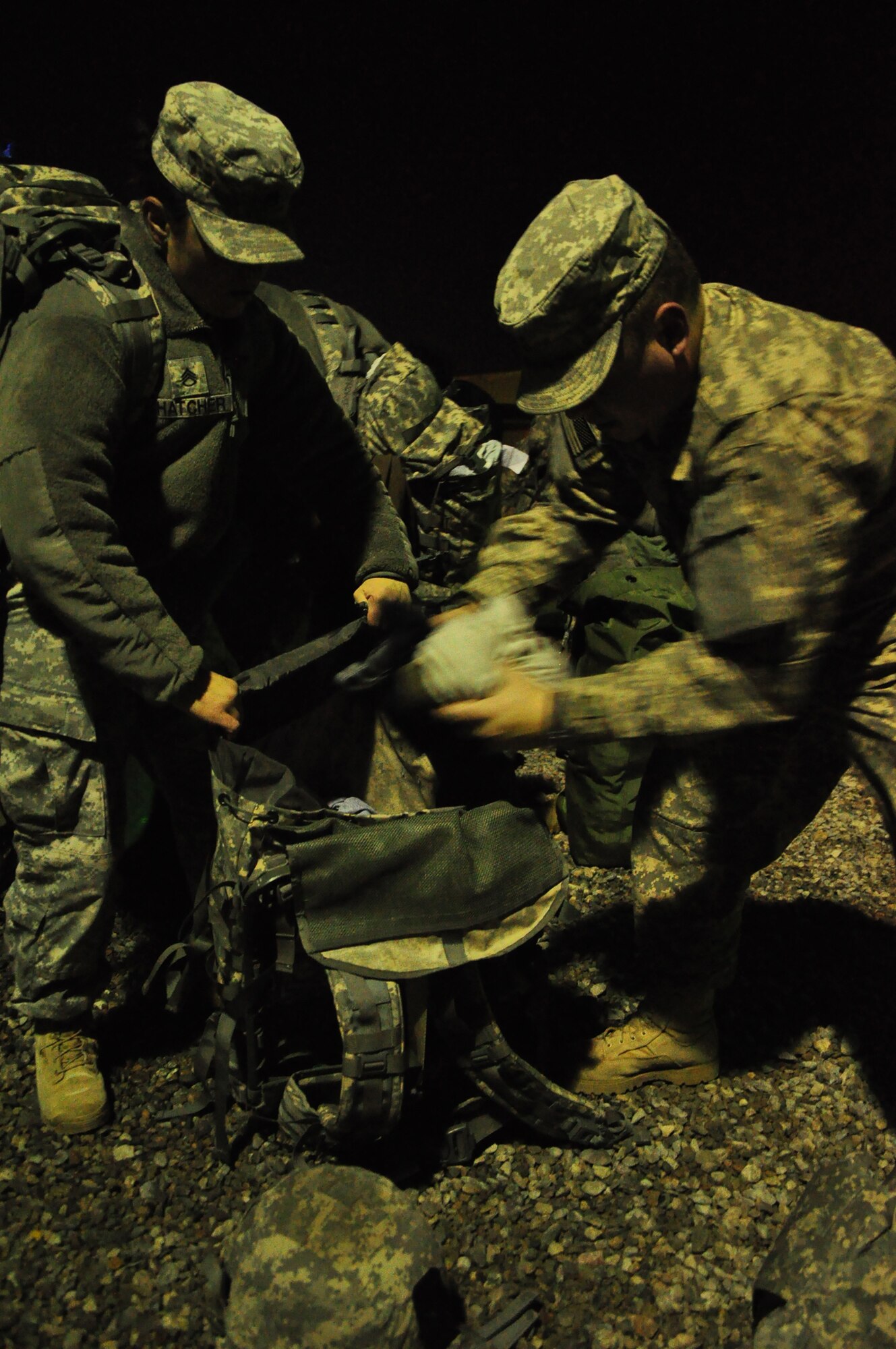 Army personnel gather their gear at night at the Transit Center at Manas. Scenes like this are a regular occurrence for the 24-hour, seven-day-a-week, operation at the Center supporting movement of personnel into and out of Afghanistan in support of Operation Enduring Freedom. Onward Movement of personnel is one of four mission pillars of the Center. The other three are Airlift, Air Refueling and Humanitarian Assistance. (U.S. Air Force photo/Master Sgt. Daniel Nathaniel III)