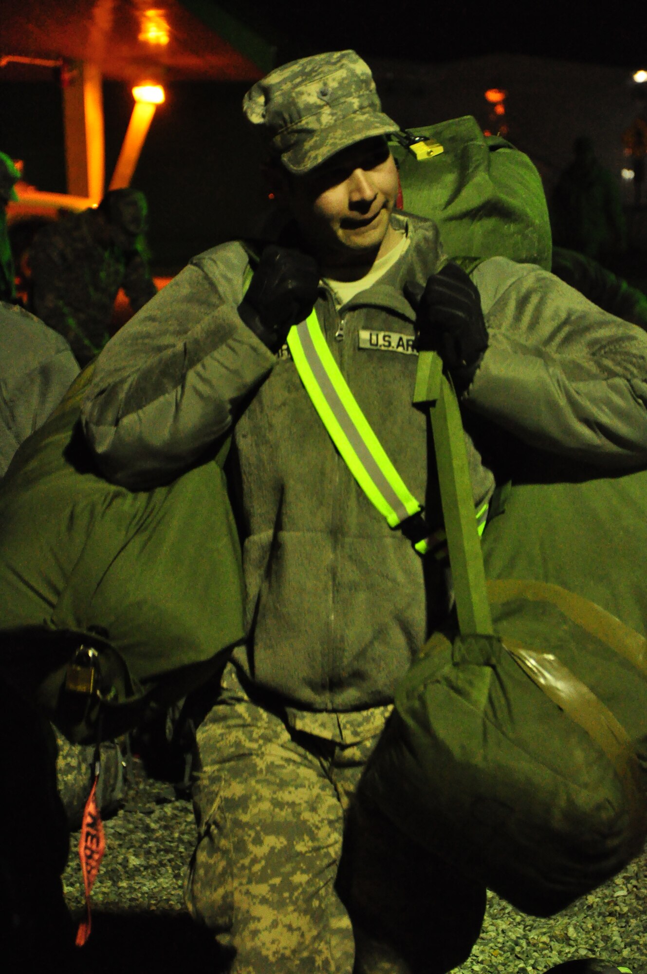 Army personnel gather their gear at night at the Transit Center at Manas. Scenes like this are a regular occurrence for the 24-hour, seven-day-a-week, operation at the Center supporting movement of personnel into and out of Afghanistan in support of Operation Enduring Freedom. Onward Movement of personnel is one of four mission pillars of the Center. The other three are Airlift, Air Refueling and Humanitarian Assistance. (U.S. Air Force photo/Master Sgt. Daniel Nathaniel III)