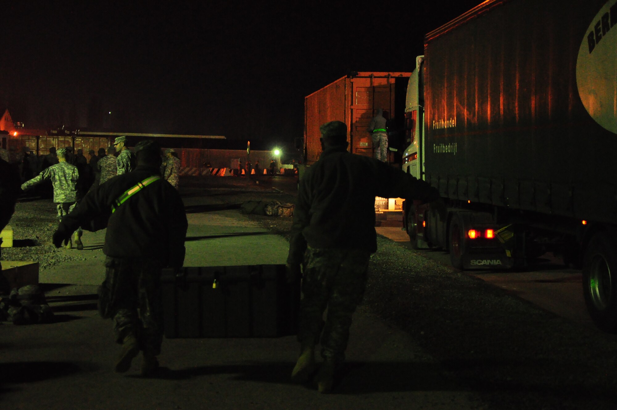 Army personnel gather their gear at night at the Transit Center at Manas. Scenes like this are a regular occurrence for the 24-hour, seven-day-a-week operation at the Center supporting movement of personnel into and out of Afghanistan in support of Operation Enduring Freedom. Onward Movement of personnel is one of four mission pillars of the Center. The other three are Airlift, Air Refueling and Humanitarian Assistance. (U.S. Air Force photo/Master Sgt. Daniel Nathaniel III)
