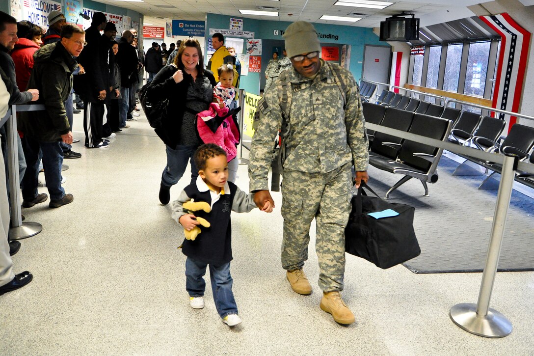 A family welcomes home a soldier at Dallas/ Fort Worth International Airport, Feb. 2, 2011. Former pro athletes, who are part of a non-profit program called Xperience Outreach, greeted returning soldiers who have been deployed to Iraq and Afghanistan. 
