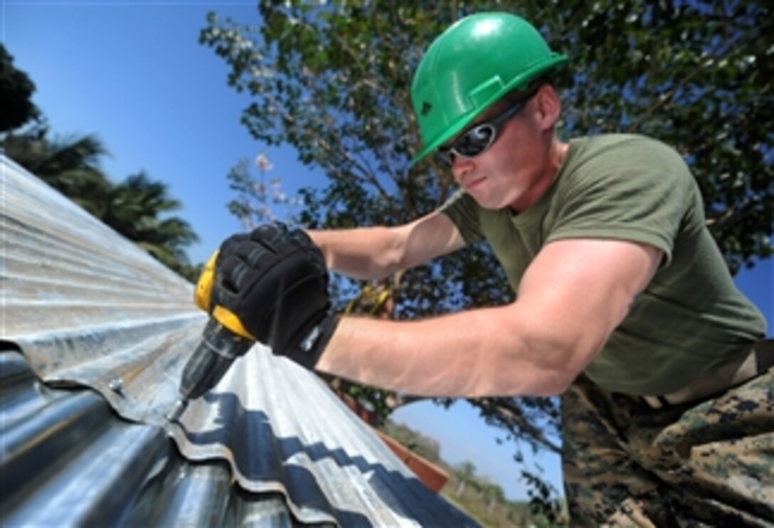 U.S. Marine Corps Lance Cpl. Stephen S. Mcdonaldhale, assigned to the 2nd Marine Logistics Group, repairs the roof of a classroom at Escuela Santa Marta in San Jose, Guatemala, during a week-long project in support of Southern Partnership Station 2011 on Jan. 31, 2011.  Southern Partnership Station is an annual deployment of U.S. ships to the U.S. Southern Command area of responsibility in the Caribbean and Latin America involving information sharing with navies, coast guards and civilian services throughout the region.  