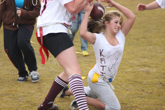 Kati Genzer, a sophmore at Matthew C. Perry High School, played running back in the Powderpuff Football game as she attempts to retrieve the ball from the opposing senior team.