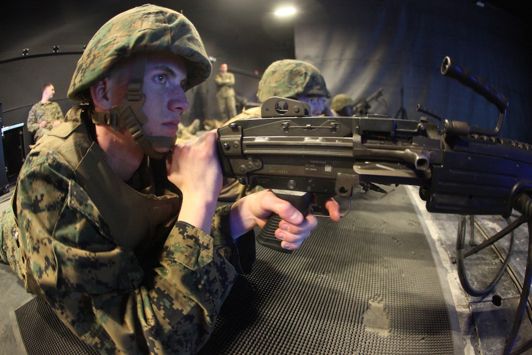 Private First Class John Winters, a Marine Corps Integrated Maintenance Management System clerk with 2nd Battalion 7th Marine Regiment, and native of Tigard, Ore., looks at his shot group at the Marine Corps Communication-Electronics School Indoor Simulated Marksmanship Trainer, Feb. 8, 2011.
