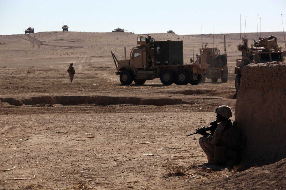 U.S. Marine Corps Sgt. Latorie Maddox with the Female Engagement Team attached to Company I, Battalion Landing Team 3/8, 26th Marine Expeditionary Unit, Regimental Combat Team 8, stands post during a shura with Marines and residents of South Gavmishi, Helmand province, Afghanistan, Feb. 8, 2011. Marines called the shura to address concerns and inform residents of the Marines' intent to assist local civilians and disrupt insurgent activities in the area. Elements of 26th Marine Expeditionary Unit deployed to Afghanistan to provide regional security in Helmand province in support of the International Security Assistance Force.