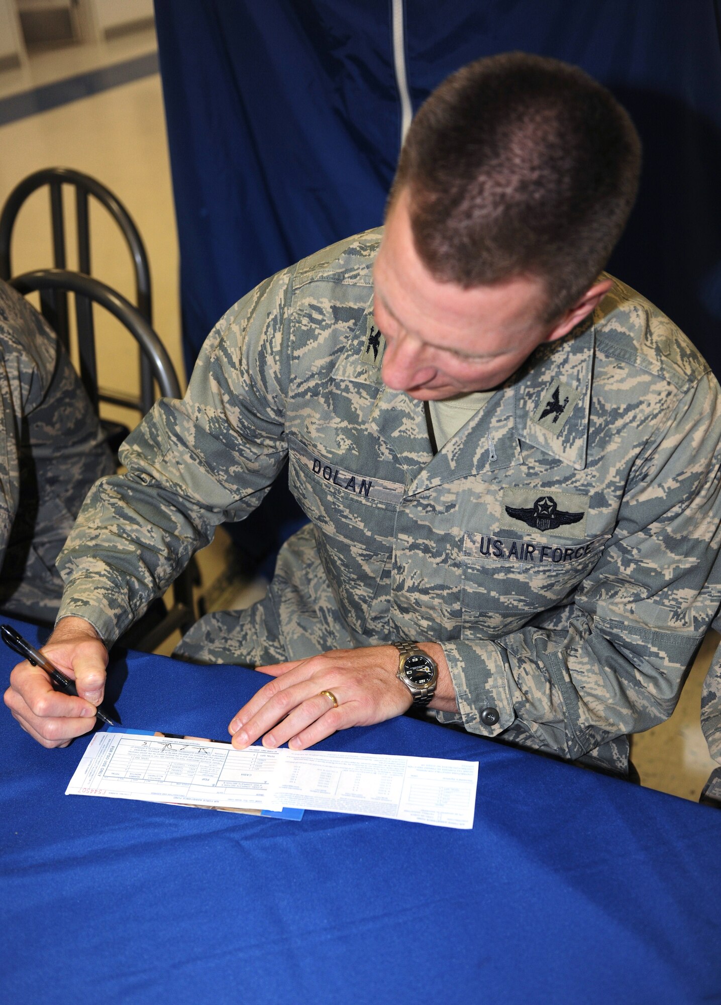 KUNSAN AIR BASE, Republic of Korea -- Col. John Dolan, 8th Fighter Wing commander signs his Air Force Assistance Fund here Feb. 8, 2010. The AFAF was established to provide for an annual effort to raise funds for the charitable affiliates that provide support to the Air Force family. Active duty installations conduct their campaigns for a six consecutive week period within the campaign window. (U.S. Air Force photo/Senior Airman Ciara Wymbs)