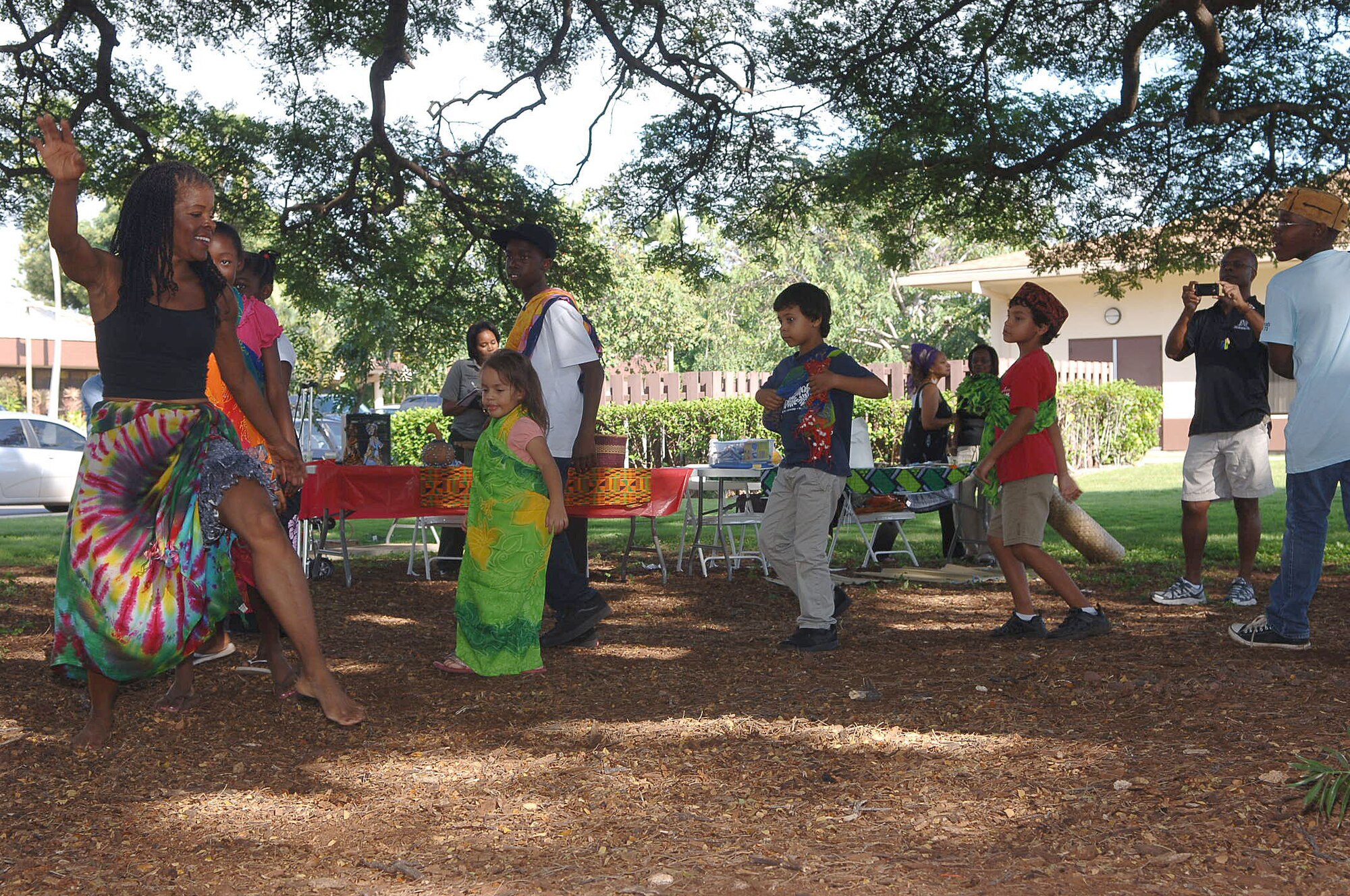 Paula Flowe, Executive Director of The Hitting Stops Here campaign, performs an African dance with children during a cultural showcase for African Americans in Hawaii on 4 Feb 2011 at the Hickam Community Center on Joint Base Pearl Harbor-Hickam, Hawaii. (U.S. Air Force photo/David D. Underwood, Jr.)